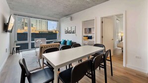 En modern lägenhet med matplats, vardagsrum och utsikt över staden.