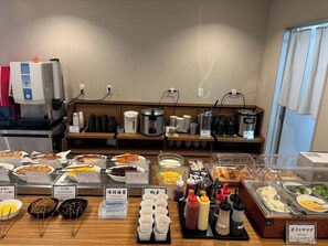 A buffet area with various food items and condiments. - Hotel Crown Hills Goi (Ichihara)