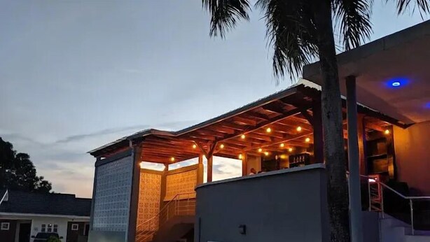A modern building with a covered outdoor area, a staircase, and a pool. - Mitros Boutique Hotel  (Abeokuta)