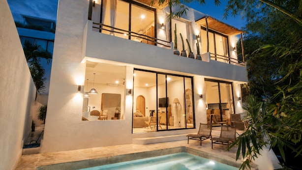 A modern two-story house with a swimming pool, large windows, and outdoor furniture. - Boho Retreat 3BR Enclosed Lounge 5min Beach (Canggu)