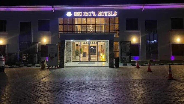 The exterior of IBD INTL HOTELS with a well-lit entrance and a paved driveway. - IBD Hotel and Suites (Abeokuta)