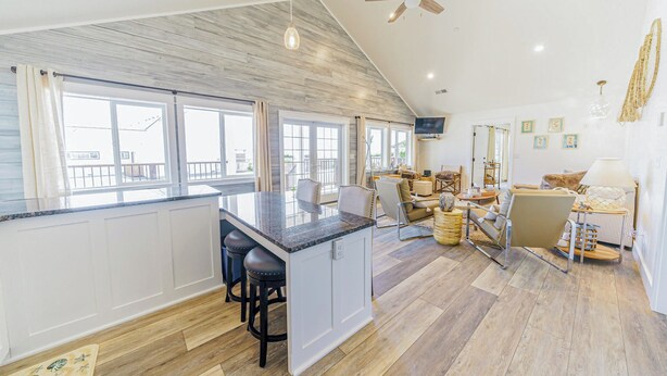 A spacious kitchen with a large island, white cabinetry, and a view to the outside. - 3 Oceanfront House in 1: Scopa 5BD + Seaview 3BD + Seasong 2BD* (Crescent City)