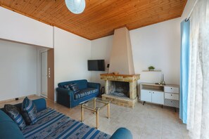 Family House, Multiple Bedrooms (To Pournari Beachside Garden House) | Living area | 21-inch flat-screen TV with cable channels, fireplace - To Pournari Beachside Garden House (Pyrgos)