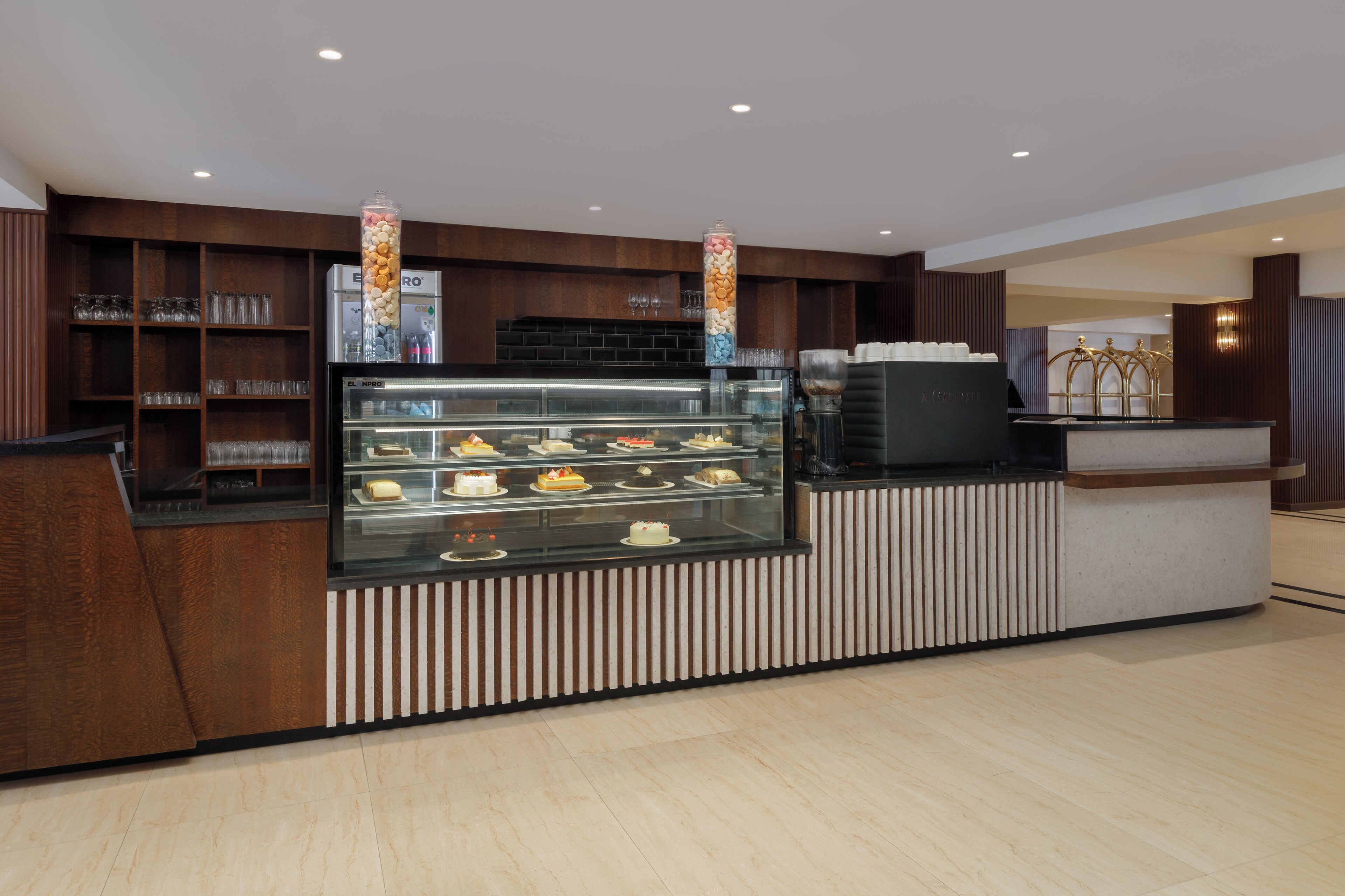 A bakery counter with various baked goods and a coffee machine.