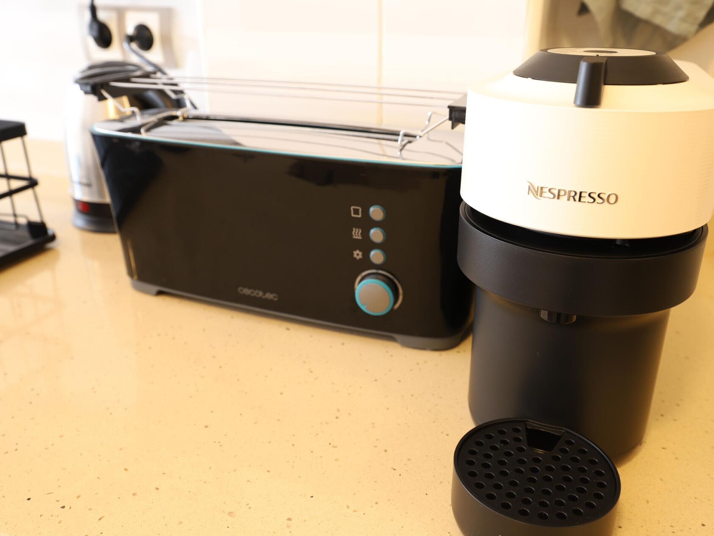 A Nespresso coffee machine and a toaster on a kitchen counter.