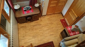 A compact room with a wooden desk, a radiator, a window with curtains, and a door. - Studio 3 ppl - Ski-in/ski-out - Val d'Isère Center - Wifi (Val-d'Isère)