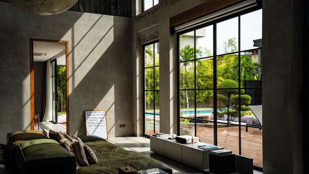 A modern living room with a large window, a sofa, and a coffee table with books. - Soul Moon Harmony - Harmony of Comfort and Nature (Kerobokan)