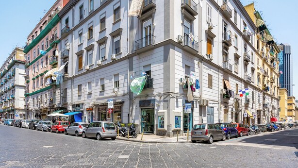 A historic building with multiple floors, large windows, and balconies. - Essentia Home (Naples)