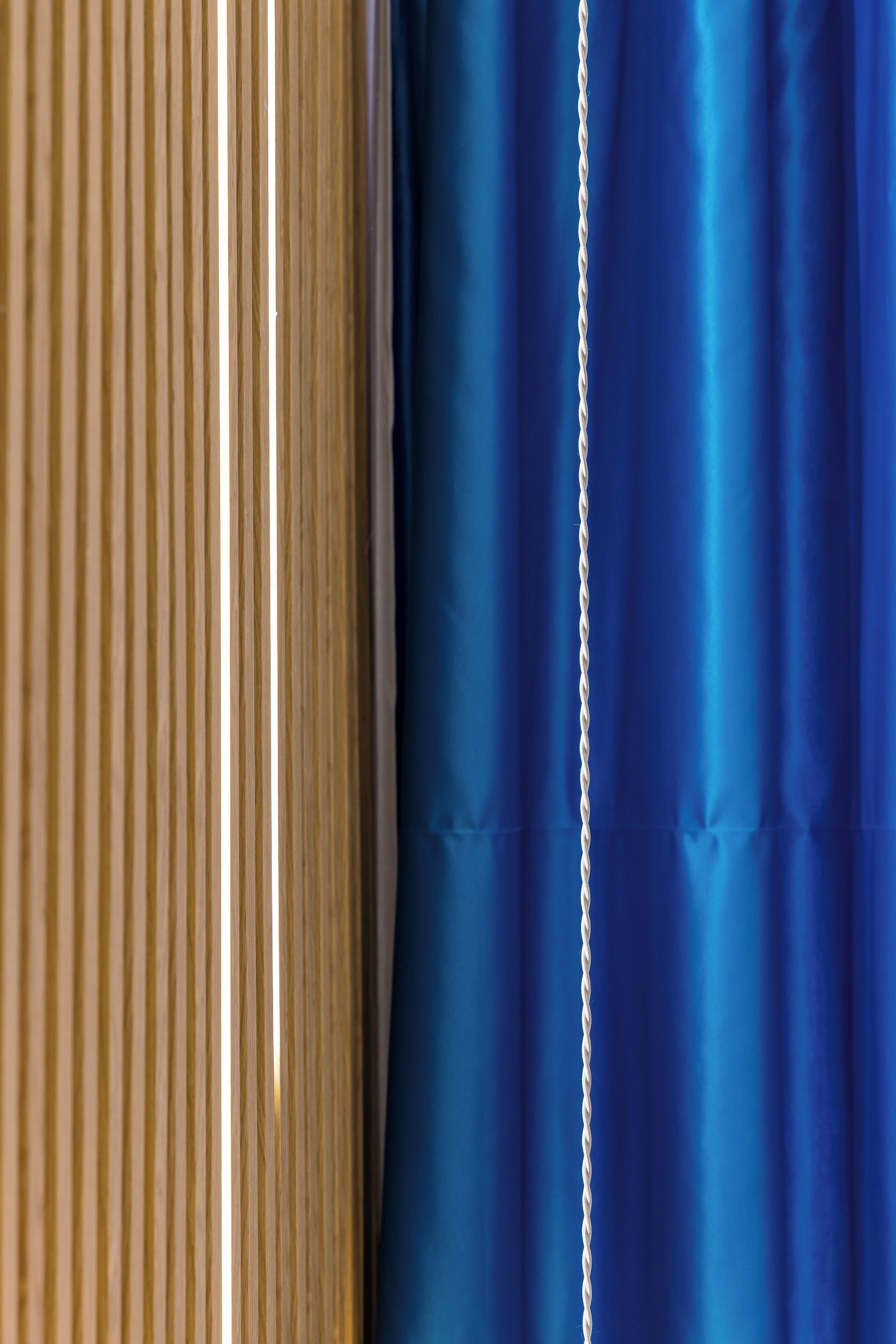 A close-up of a curtain with a chain detail.