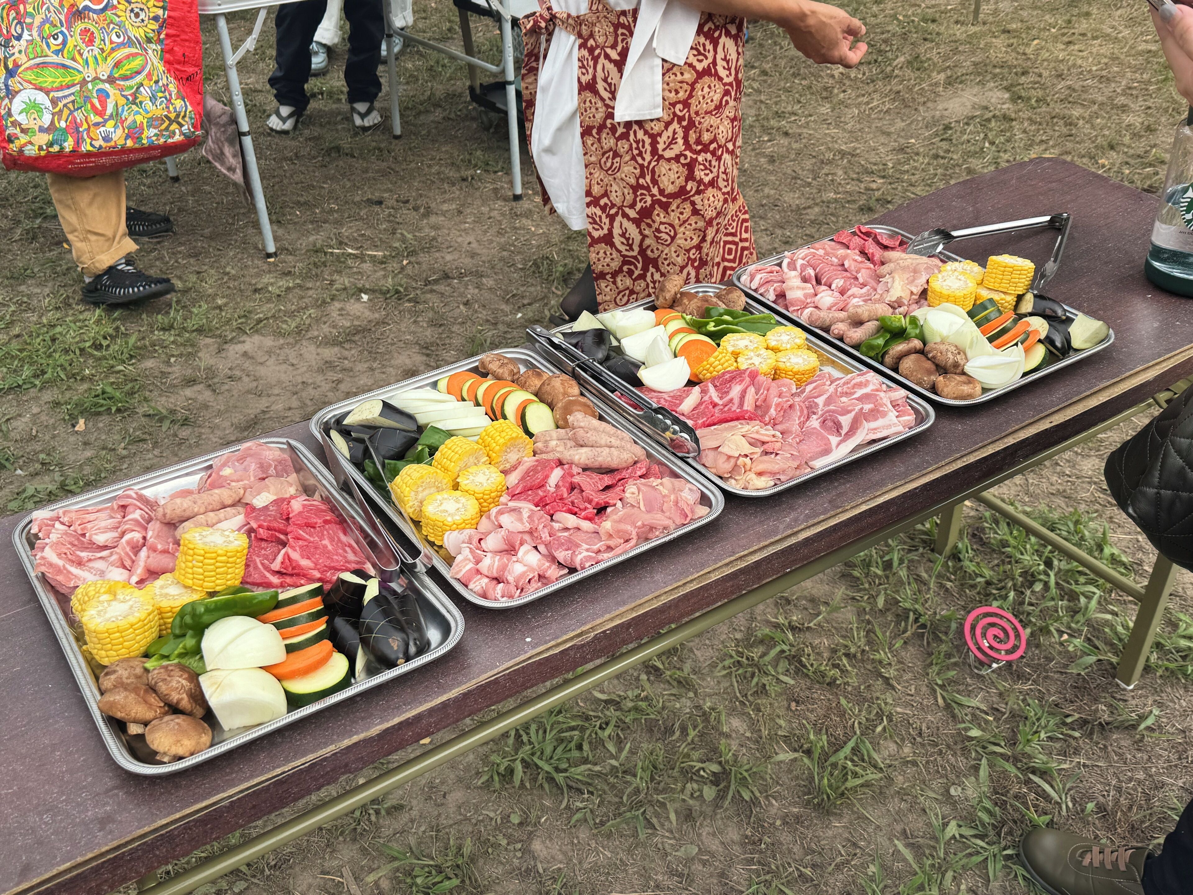 A buffet table with various meats and vegetables.