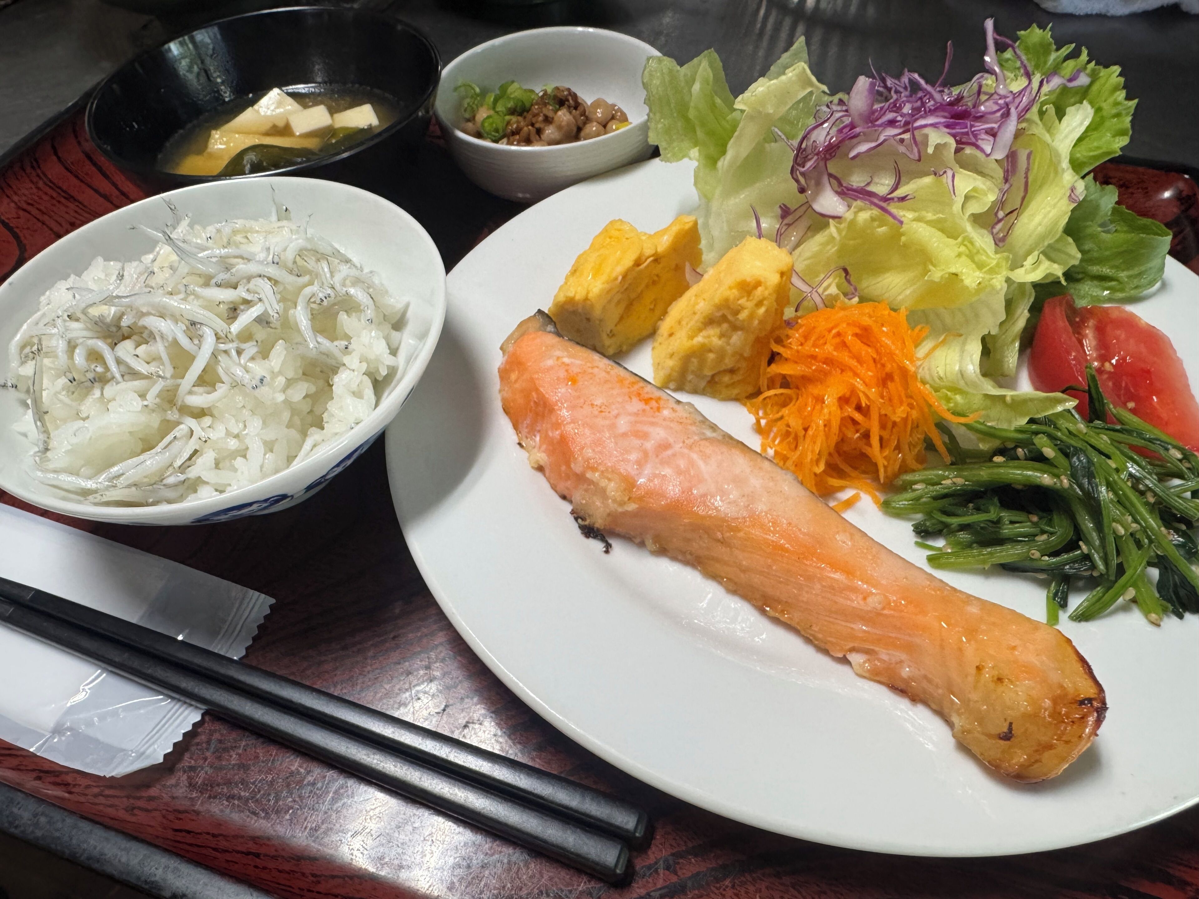 A plate with salmon, rice, and vegetables.