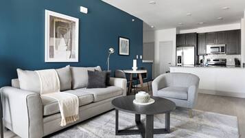 Apartment, 1 Bedroom | Living area | 50-inch TV with digital channels