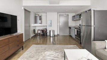 Apartment, 1 Bedroom | Living area | 50-inch TV with digital channels