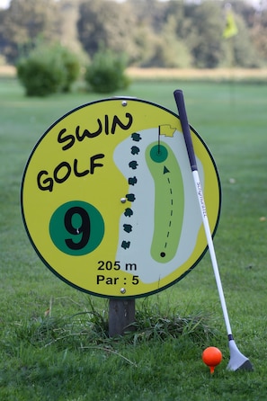 Señal de campo de golf con el texto 'SWIN GOLF' y una distancia de '205 m'.