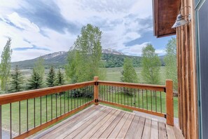 A wooden deck with a metal railing overlooking a mountainous landscape. - Slate View Dreams,  Close to CB, hot tub, deck, patio, firepit, views! (Crested Butte)
