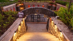 A stone staircase leading up to a covered area with a sign in a foreign language. - Lavender Villa by Ebony Stays – Peaceful 3 BHK Getaway in Nashik (Gangavhare)