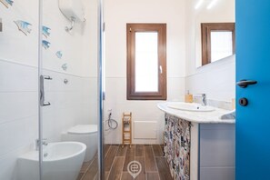Een douche, een haardroger, een bidet, handdoeken