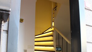 A modern staircase with illuminated steps, a digital display, and a black door frame. - Şah Bey Konağı (Istanbul)