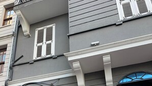 A building with a black door, a metal gate, and a sign with the text 'KONAGI'. - Şah Bey Konağı (Istanbul)