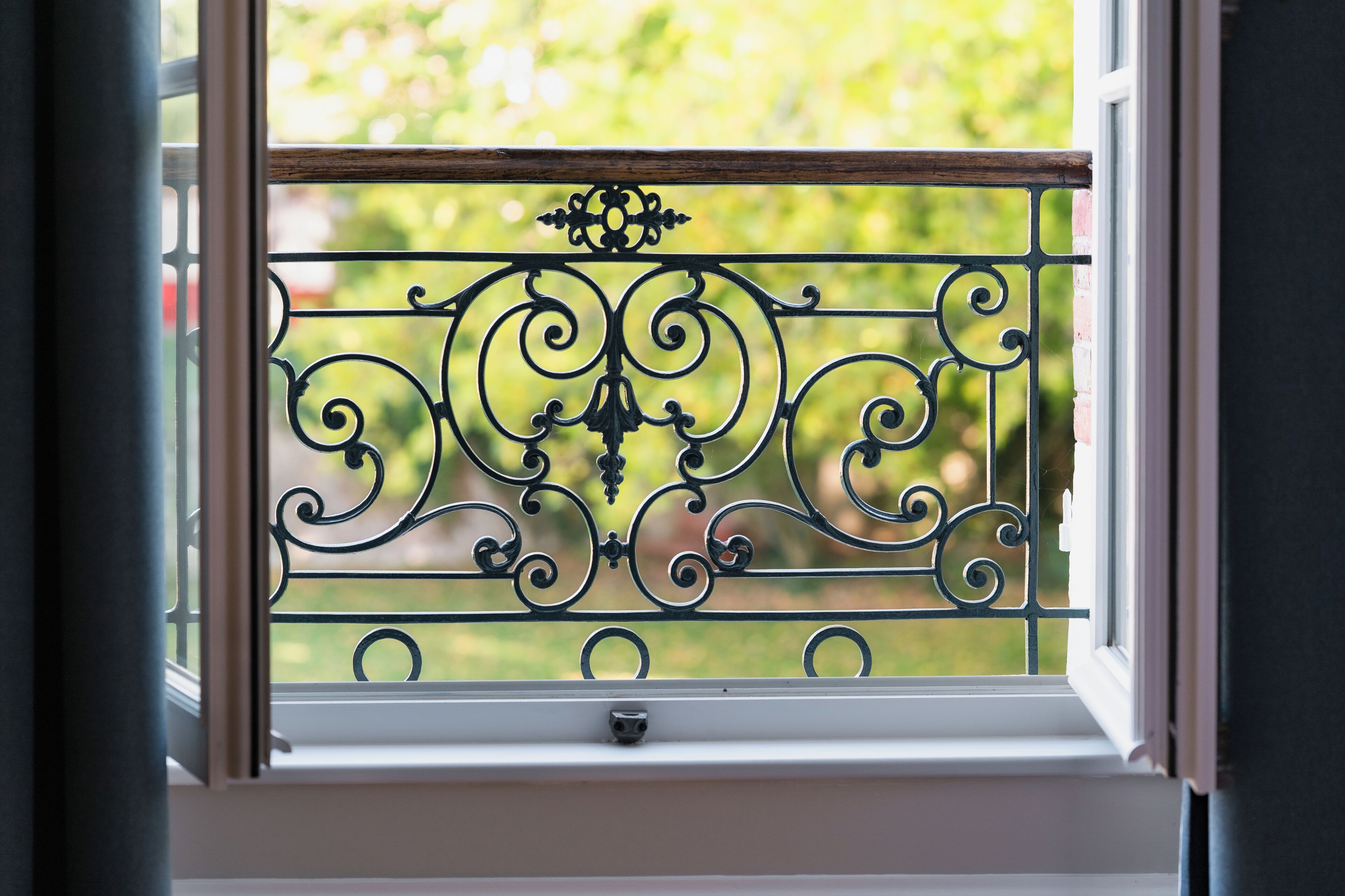 A window with a decorative metal grille.