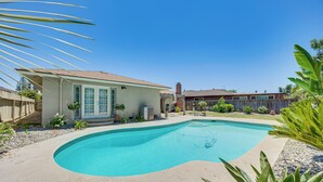 A backyard with a swimming pool, a small house, and a wooden fence. - Shop, Hike & Explore: Fresno Home w/ Private Pool! (Fresno)