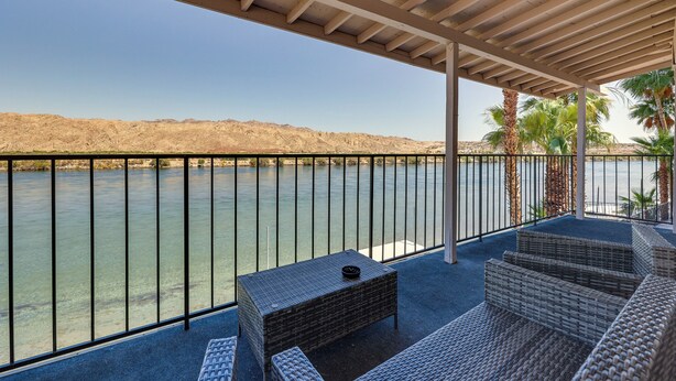 A covered outdoor seating area with a view of a river and distant hills. - Colorado River Retreat: Bullhead City Home w/ Deck (Bullhead City)