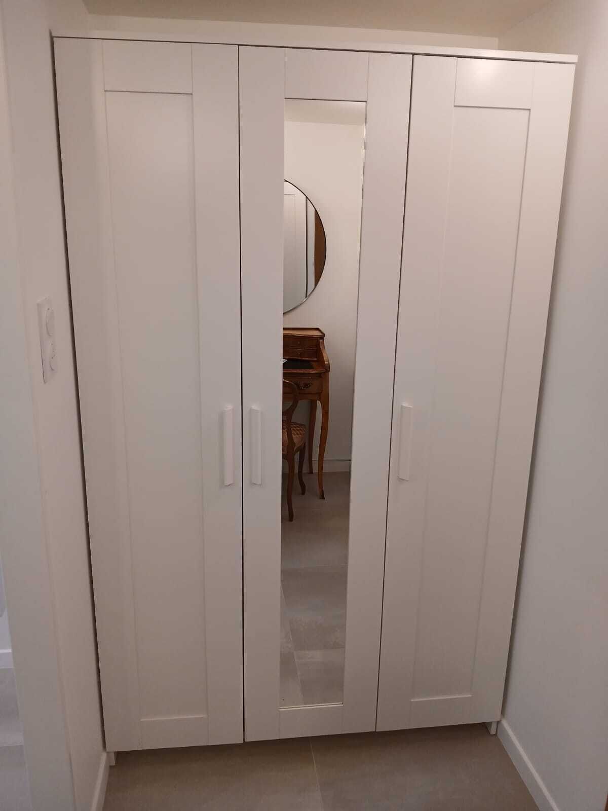A white wardrobe with two doors and a mirror.