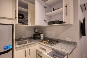Fridge, microwave, stovetop, dining tables