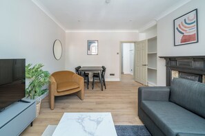 Basic Apartment, City View | Living area | 50-inch LED TV with digital channels