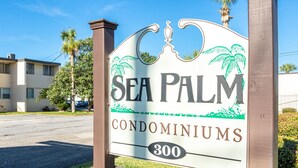 A sign for Sea Palm Condominiums with a number 300.