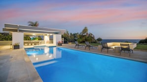 A modern outdoor pool area with lounge chairs and a covered seating area. - Morning View Malibu -Malibu Masterpiece in the Making w/ Views & Beach Access (Malibu)