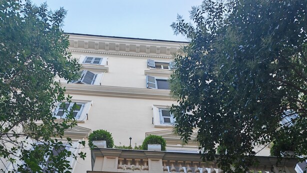 A building facade with a large arched entrance, a number '36' sign, and a balcony with potted plants. - AD Vatican Luxury Rooms (Rome)