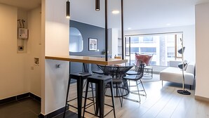 A modern kitchen with a central island, bar stools, and pendant lighting. - Relaxing 3BR @Commercial Area near Zona G (Bogotá)