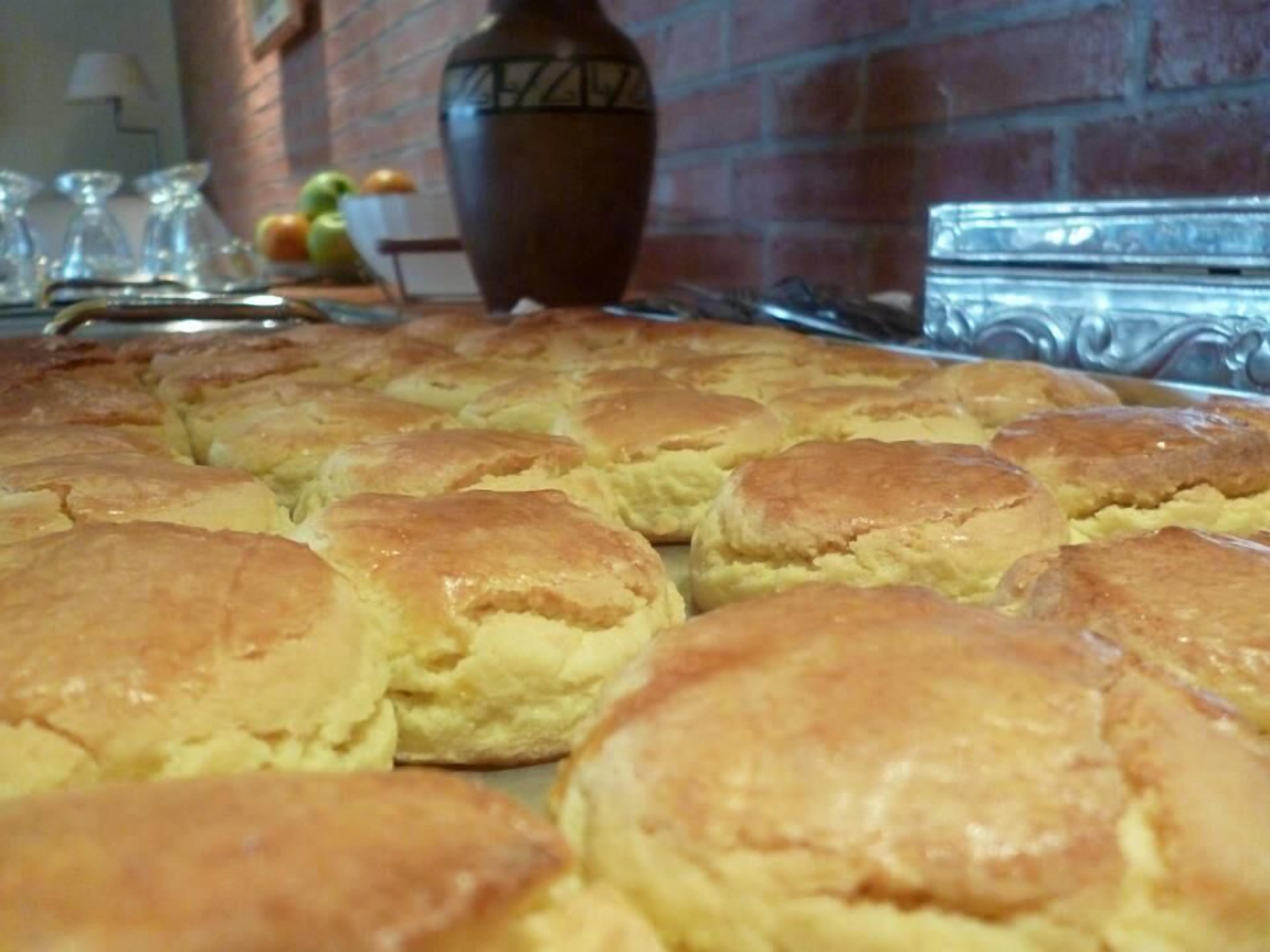 A tray of freshly baked biscuits arranged on a table.