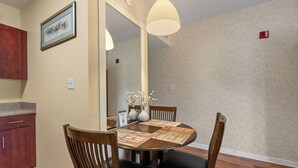 A dining area with a round table, wooden chairs, and a vase with flowers. - 1 BR Close to the Action, Far from the Crowds - Pools-Mtn View (Pigeon Forge)
