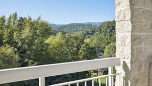 A balcony with a view of a forested mountain range. - 1 BR Close to the Action, Far from the Crowds - Pools-Mtn View (Pigeon Forge)