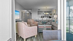 A modern living room with a sofa, armchairs, and a dining table. - Captiva Beachfront Condo 2322 | Direct Gulf Front | Pool, Tennis & Pickleball (Captiva)