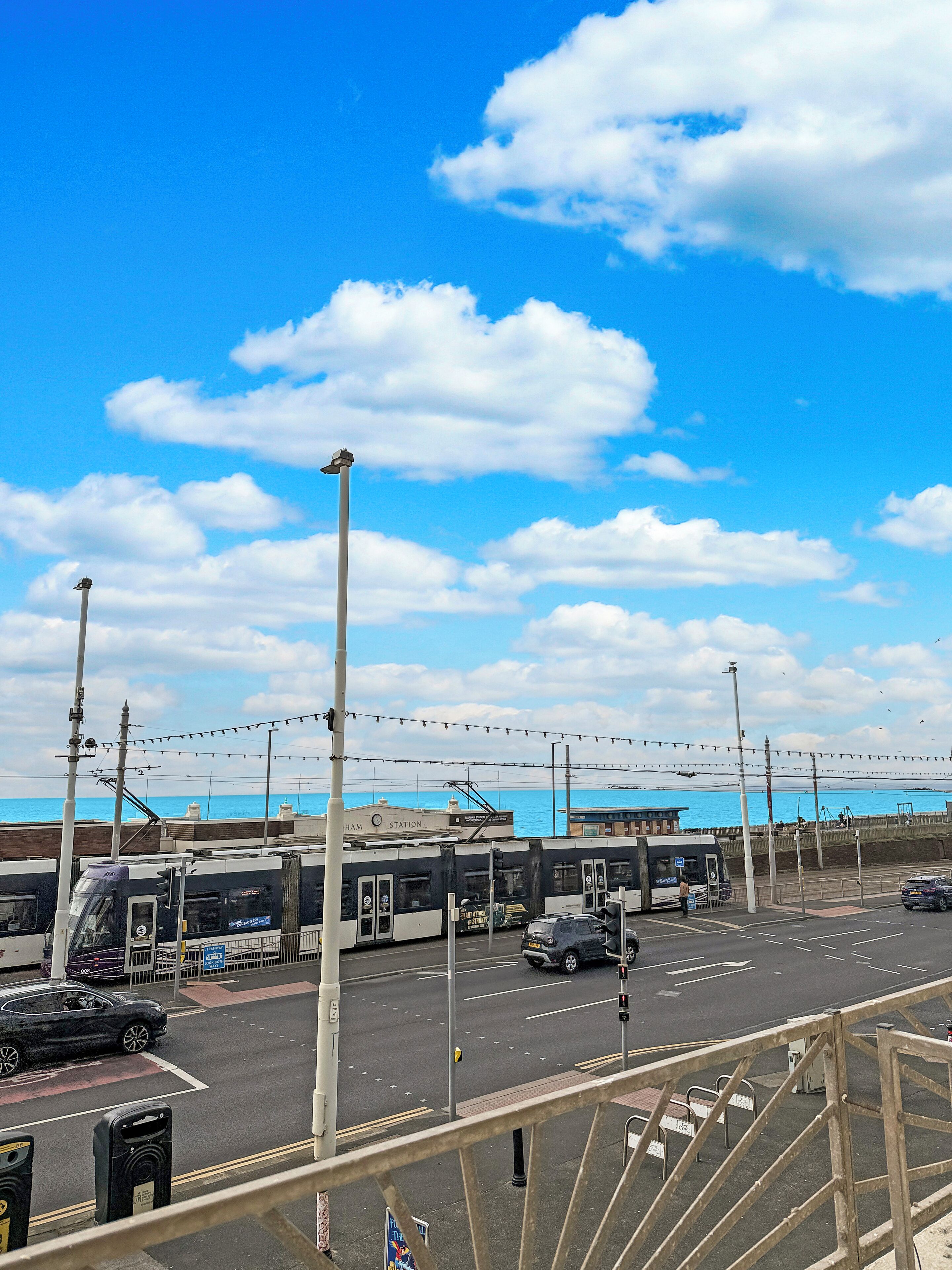 A train station with a clear view of the sea in the background.