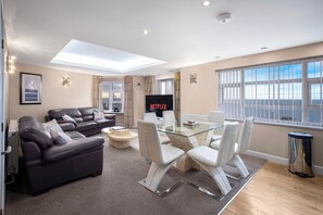 10 Queen Suite 5-Star, 3 Bedrooms, Sea View, Beachfront (plus 1 free baby) | Living area | 50-inch Smart TV with digital channels, Netflix, streaming services - Granada Apartments Queens Mansions (Blackpool)