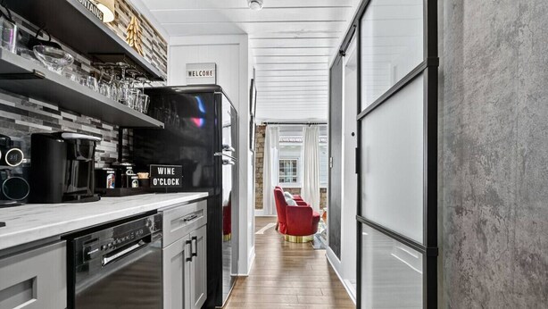 A modern kitchen with a coffee machine, wine refrigerator, and a welcome sign. - Luxury Suite in the heart of downtown Blue Ridge (Blue Ridge)