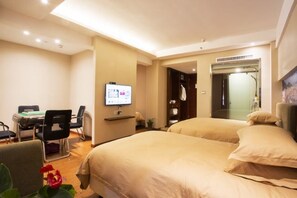 A hotel room with two beds, a desk with a computer, a TV, and a bathroom with a mirror and shower. - Zhoushan Shenjiamen Zhongjing Hotel(Banshengdong Passenger Terminal Branch) (Zhoushan)