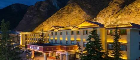 A hotel with a traditional architectural style, featuring multiple stories and a prominent entrance.