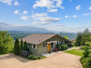 A single-story house with a sloped roof, a front porch, and a small attached garage.