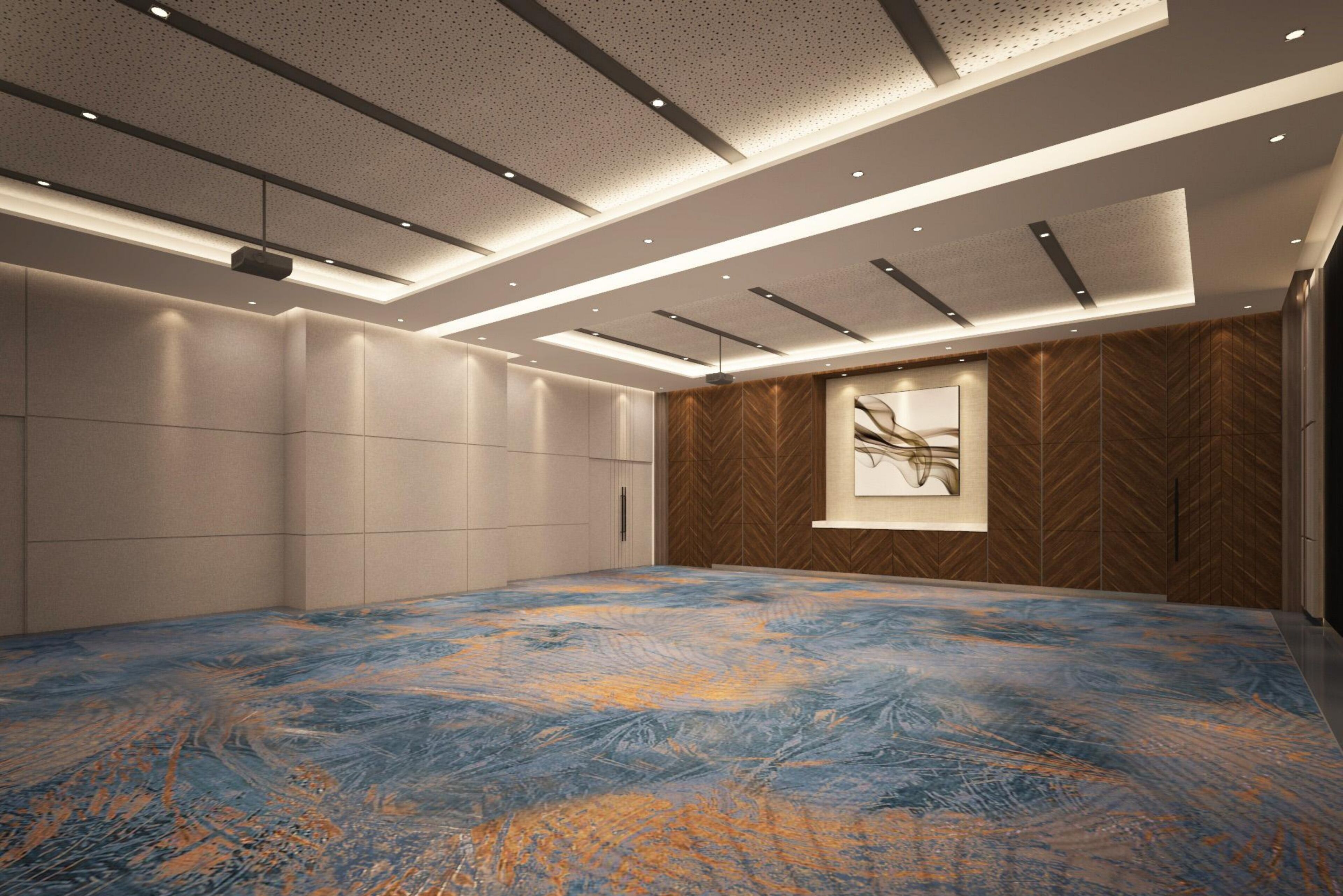 A modern hotel room with a large, patterned floor, recessed ceiling lighting, and a large window with a view.