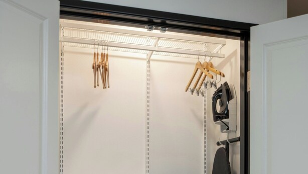 A walk-in closet with open shelves, hanging space, and a large mirror. - Towneplace Suites By Marriott Surprise Prasada (Surprise)