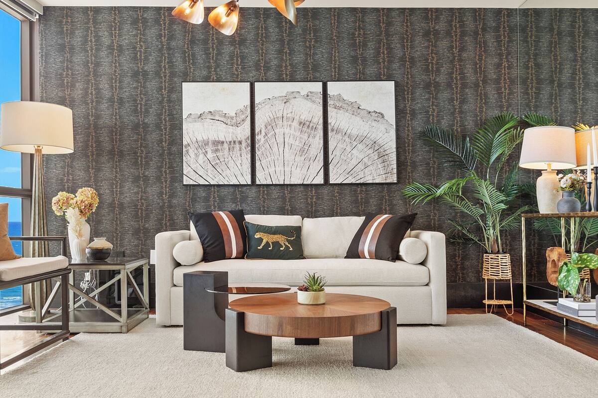 A modern living room with a sofa, coffee table, and artwork on the wall.