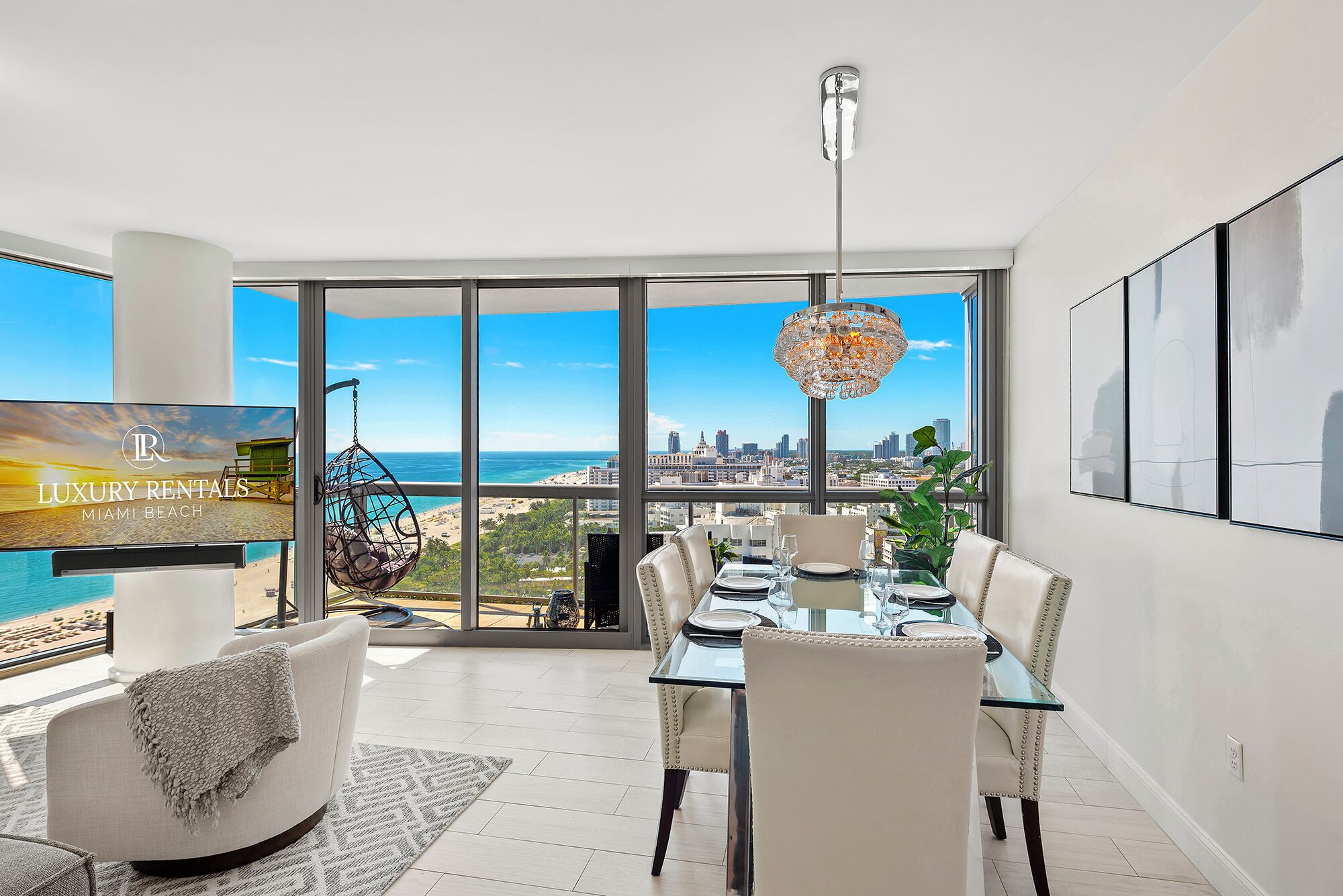 A spacious dining area with a city view, a hanging chair, and a large window.