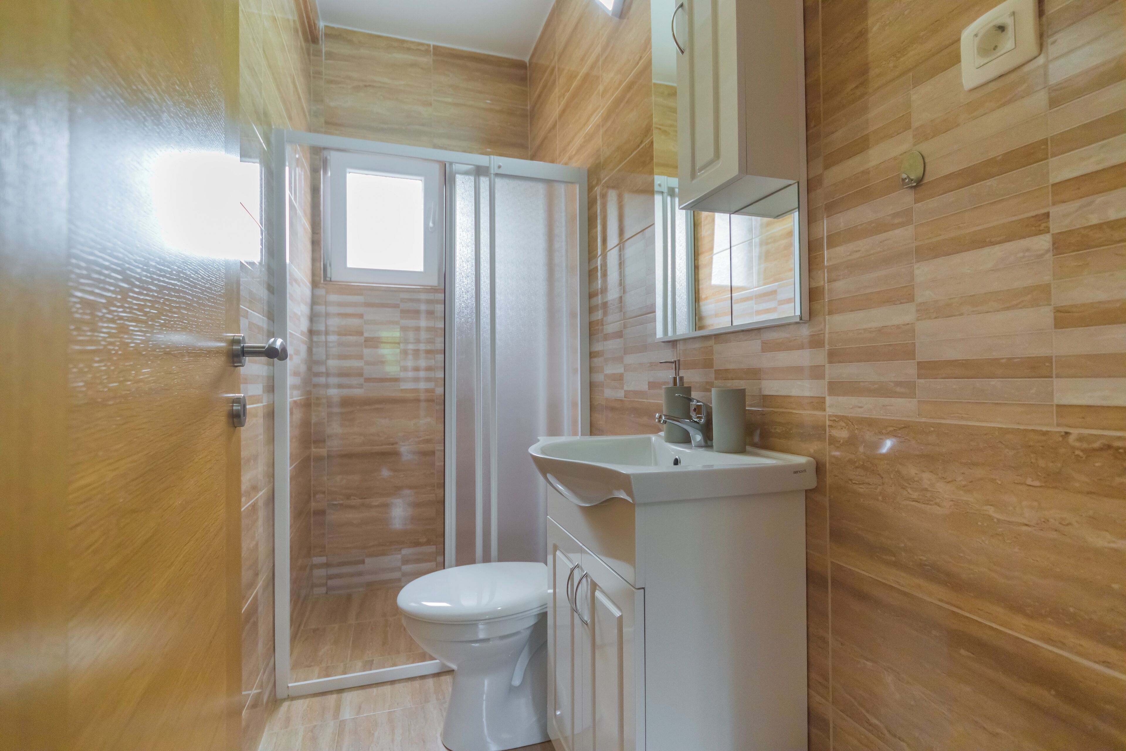 Ein Badezimmer mit Toilette, Waschbecken und Spiegel.