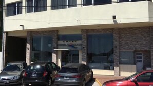 A motel with a sign reading "MOTEL TERRADA". There are four cars parked in front, and the building has a modern design with large windows and a stone facade. - Terra do Mar (San Bernardo del Tuyú)