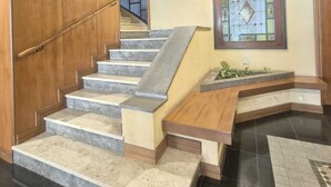 A staircase with marble steps and wooden railings, leading to a landing with a decorative glass panel. - If you feel like (Palermo)